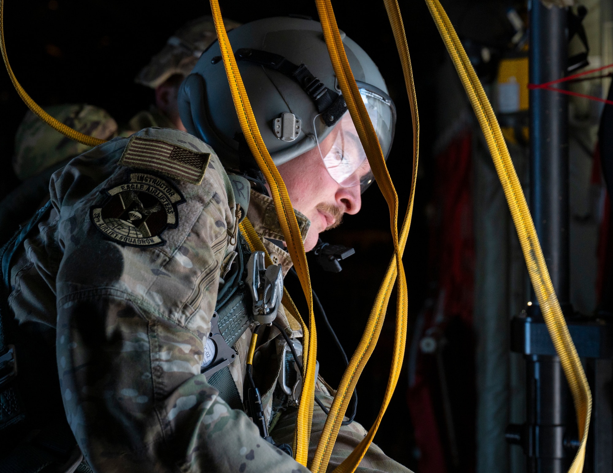 A loadmaster recovers static line after personnel jump during exercise North Wind 26.