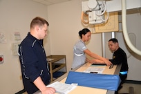 Army, Navy, and Air Force Radiologic Technologist students learn to position patients while working on each other in the non-live laboratory at the Medical Education and Training Campus at Joint Base San Antonio-Fort Sam Houston, Texas. Radiologic technologists are allied healthcare professionals who perform radiographic procedures and related patient care duties to help diagnose various medical ailments. The METC Radiologic Technologist course provides training in radiation physics, anatomy and physiology, theory and practice of fixed and mobile radiologic equipment, chemical and digital processing, and routine and special radiographic positioning. The course is conducted in two parts; resident training is conducted at METC followed by clinical training conducted at military medical treatment facilities. (Photo by Lisa Braun)