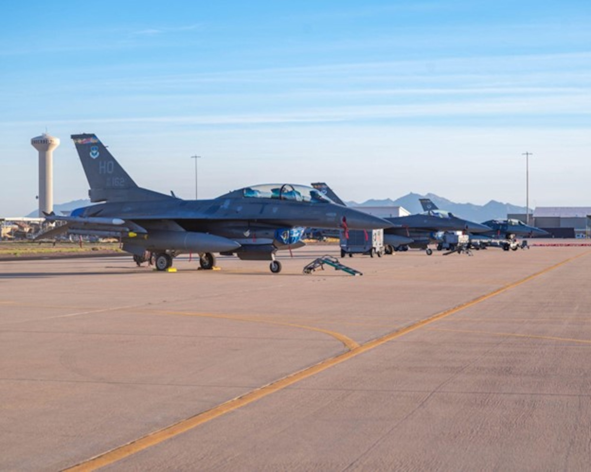 F-16 Fighting Falcons assigned to Holloman Air Force Base and F-35 Lightning IIs assigned to the 56th Fighter Wing sit on the flightline in preparation for a joint training exercise, Jan. 27, 2026, at Luke Air Force Base, Arizona.  Success in the air relies on coordinated efforts on the ground. Maintenance Airmen from both bases work side by side to keep aircraft mission-ready, executing inspections, repairs and turnarounds under demanding timelines. Weapons crews safely and efficiently configure aircraft with the required munitions, ensuring each sortie launches fully capable.