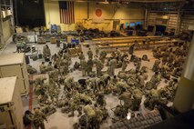 U.S. Army paratroopers assigned to the 11th Airborne Division, 2nd Brigade, prepare to rig equipment during exercise North Wind 26.
