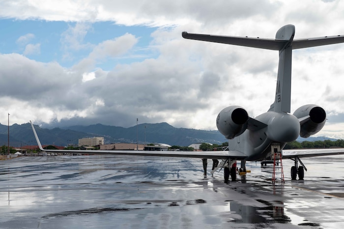 A U.S. Air Force EA-37B Compass Call sits on the flightline at Joint Base Pearl Harbor-Hickam, Hawaii, Oct. 1, 2025. The aircraft, assigned to the 55th Electronic Combat Group, launched from Offutt Air Force Base for a roadshow across the Indo-Pacific. (U.S. Air Force photo by Senior Airman Mark Sulaica)