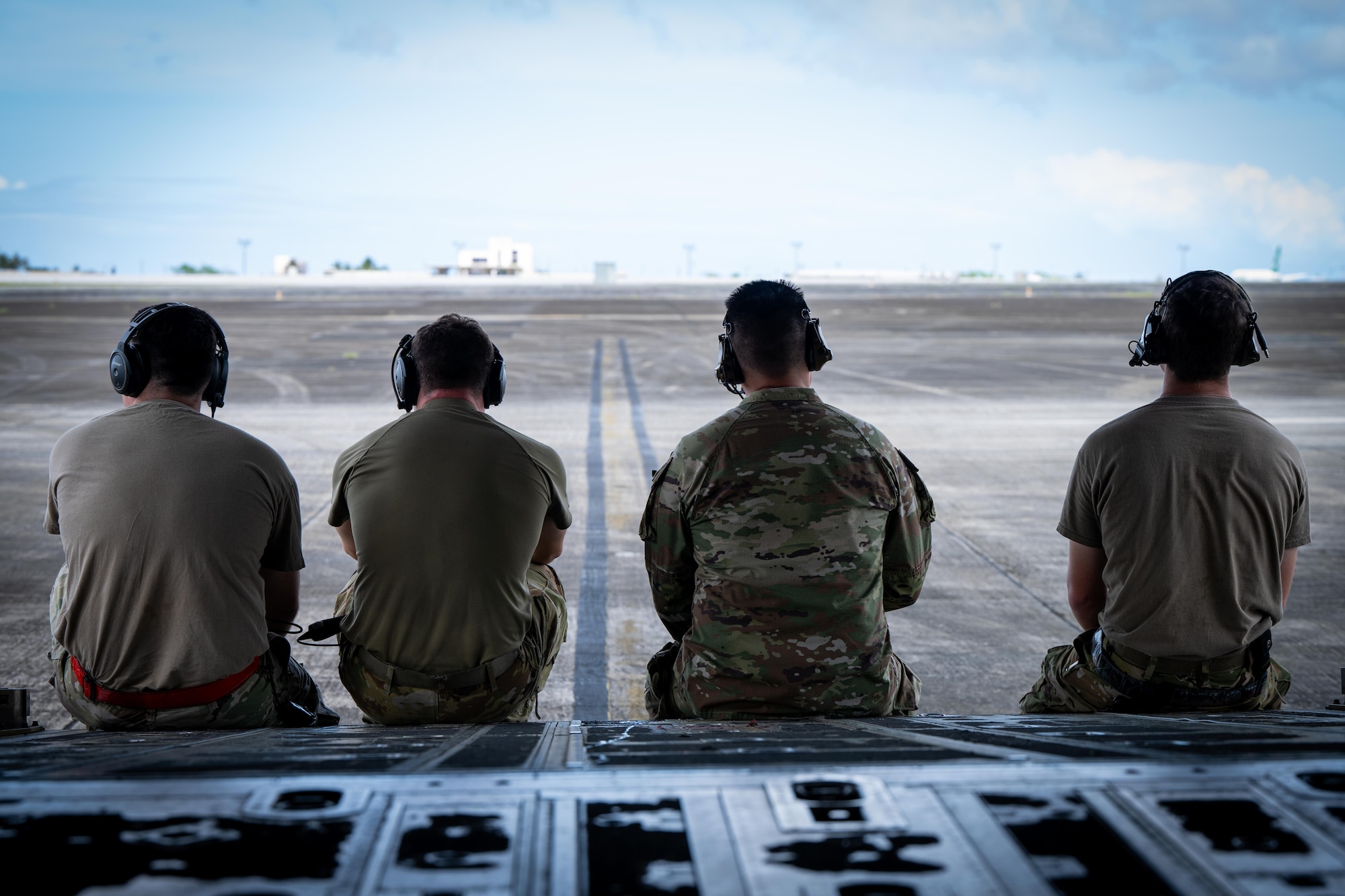 U.S. Air Force Airmen assigned to the 317th Aircraft Maintenance Squadron and 317th Maintenance Squadron sit on the ramp of a C-130J Super Hercules assigned to the 317th Airlift Wing during Exercise Palmetto Reach at Won Pat International Airport, Guam, Jan.17, 2026. As part of the exercise, the 317th AW deployed a C-130J, aircrews and maintenance personnel to Guam to support Joint Base Charleston’s Combat Readiness Exercise and validation event, integrating with C-17 Globemaster III and KC-46 Pegasus aircraft to enhance mobility operations. (U.S. Air Force photo by Airman 1st Class Adrien Tran)