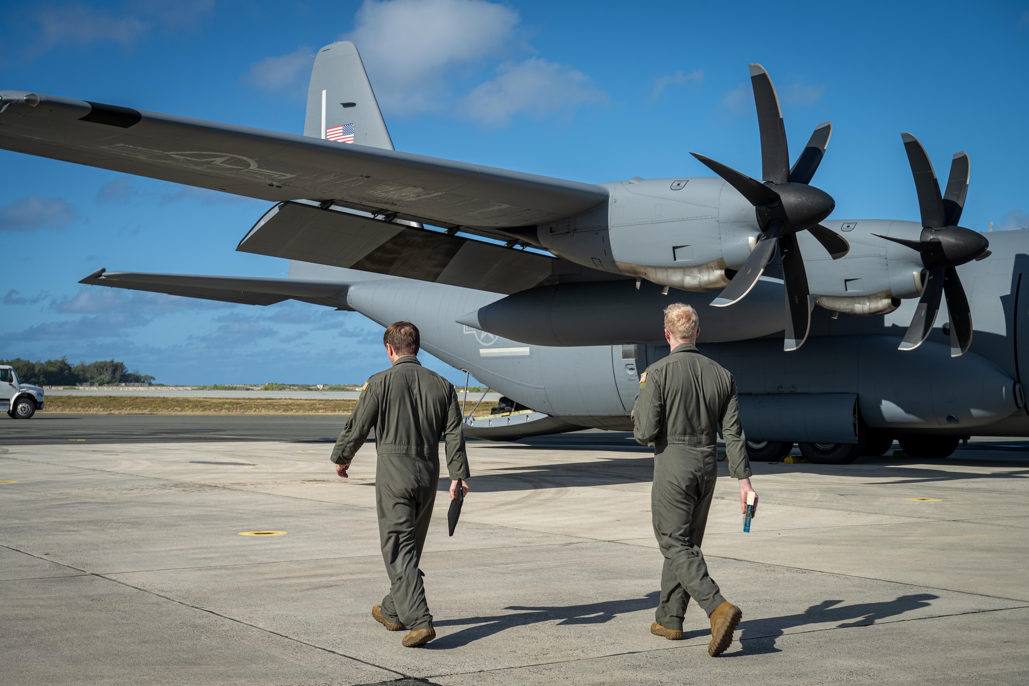 U.S. Air Force Capt. Carter Sweat, left, and 1st Lt. Mason Berger, 39th Airlift Squadron pilots, walk towards a C-130J Super Hercules assigned to the 317th Airlift Wing during Exercise Palmetto Reach at Wake Island, Jan. 14, 2026. The 317th AW joined the 437th Airlift Wing, from Joint Base Charleston, South Carolina, to participate in their Combat Readiness Exercise. (U.S. Air Force photo by Airman 1st Class Adrien Tran)