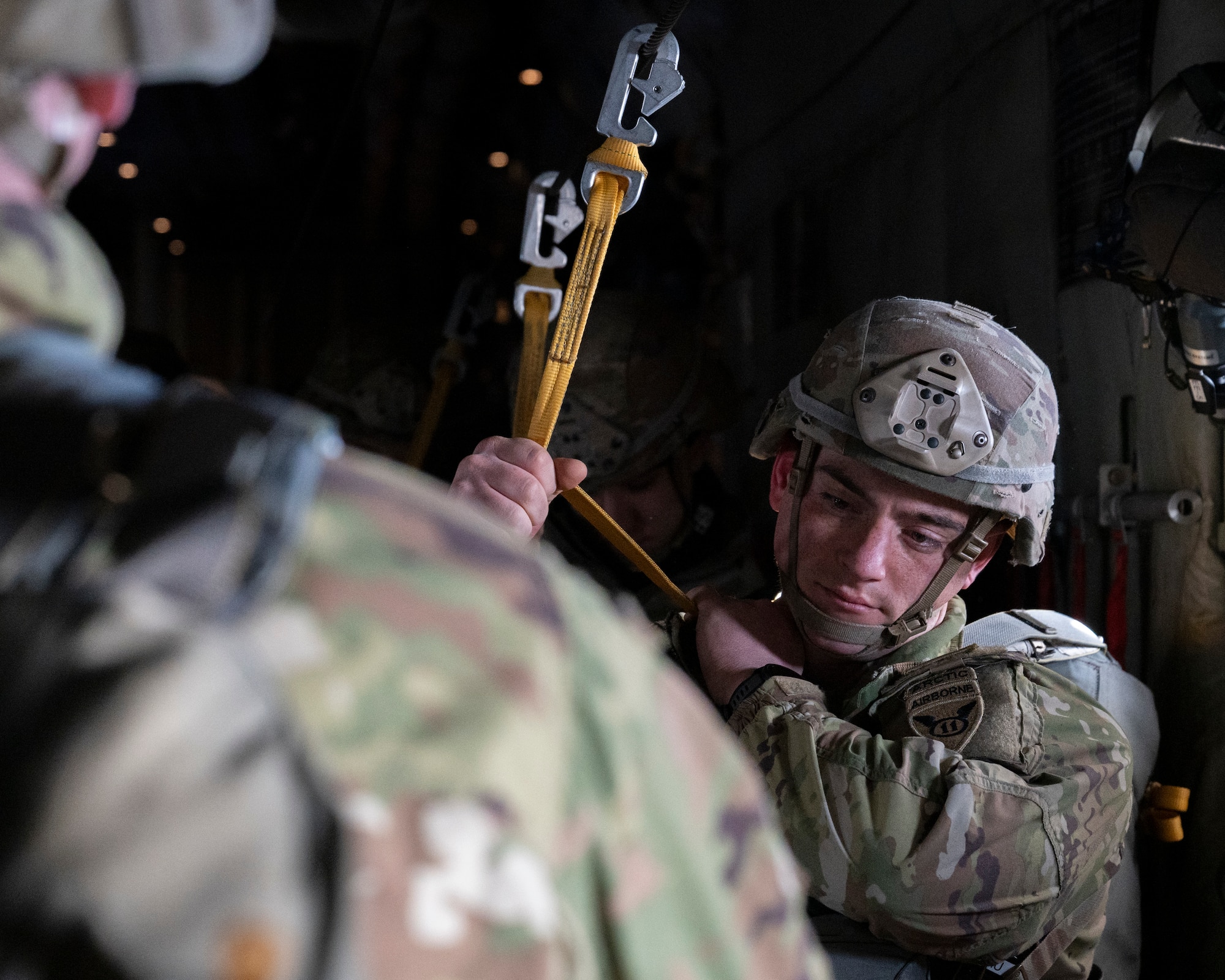 A U.S. Army paratrooper assigned to the 11th Airborne Division, 2nd Brigade, prepares to execute a static line jump during exercise North Wind 26.