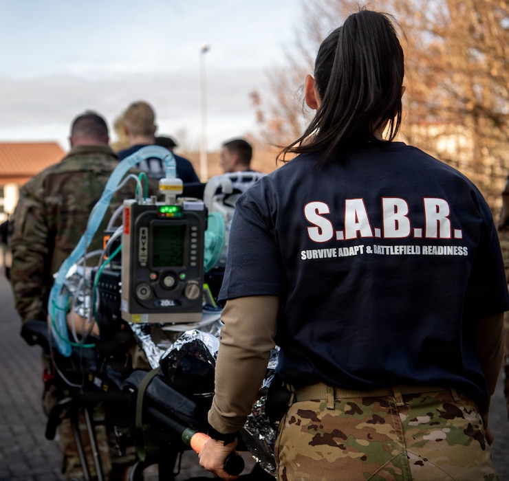 Cadre assist U.S. Air Force Airmen, assigned to the 86th Medical Group, carry a gurney during Survive, Adapt and Battlefield Readiness exercise at Landstuhl Regional Medical Center, Germany, Jan. 22, 2026.