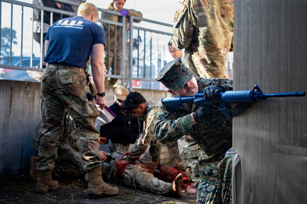 U.S. Air Force Airmen, Army, Marines and Navy medical personnel work together to guard and perform triage for a simulated patient at Survive, Adapt and Battlefield Readiness exercise at Landstuhl Regional Medical Center, Germany, Jan. 22,. 2026.