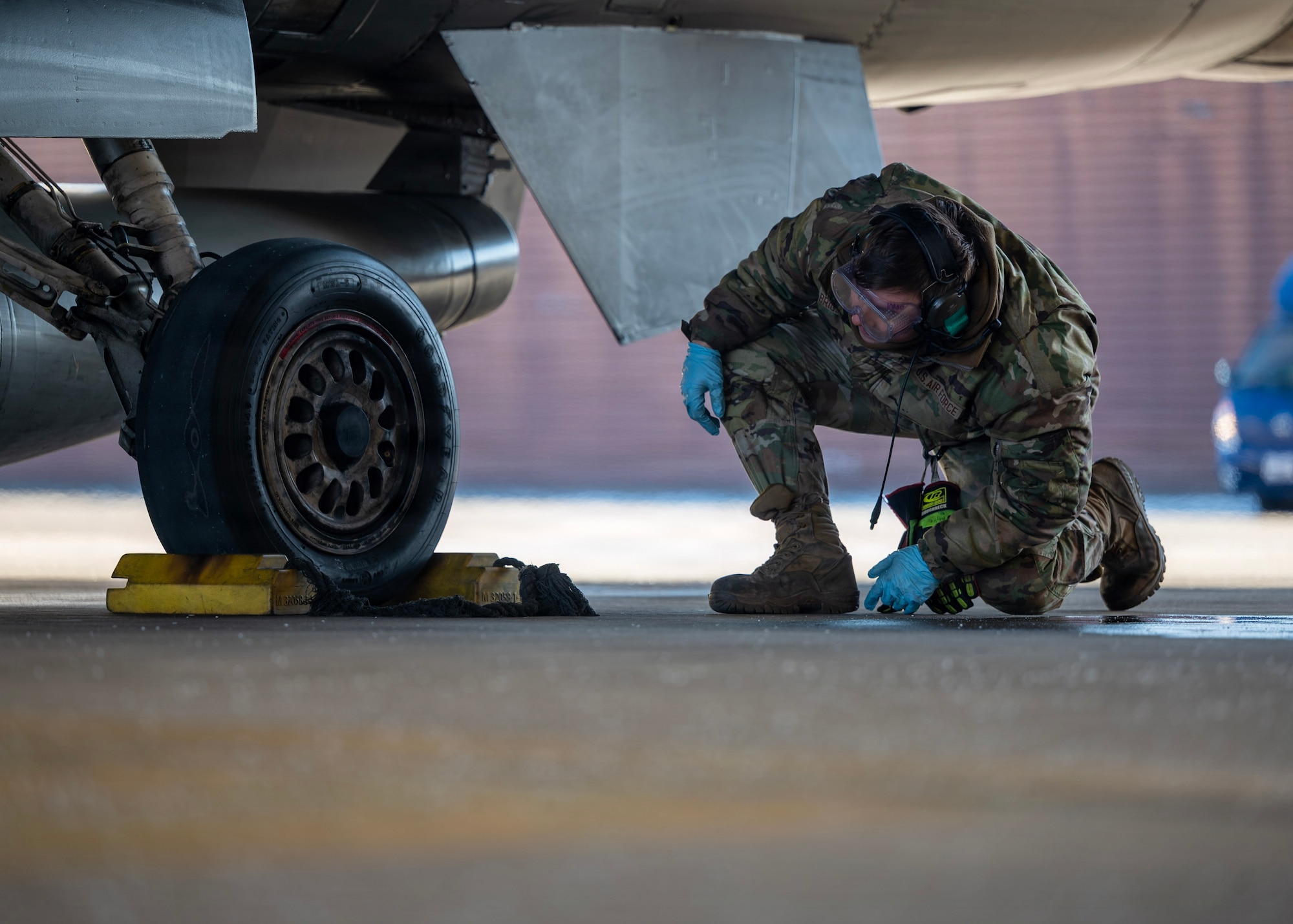 U.S. Air Force Airman 1st Class Benjamin Patterson, 51st Logistics Readiness Squadron petroleum, oils, and lubricants distribution operator, inspects an F-16 Fighting Falcon tire during a hot-pit refueling operation at Osan Air Base, Republic of Korea, Jan. 27, 2026. Maintenance and POL Airmen worked side by side during hot-pit operations to safely refuel and rapidly relaunch aircraft. (U.S. Air Force photo by Staff Sgt. Sarah Williams)