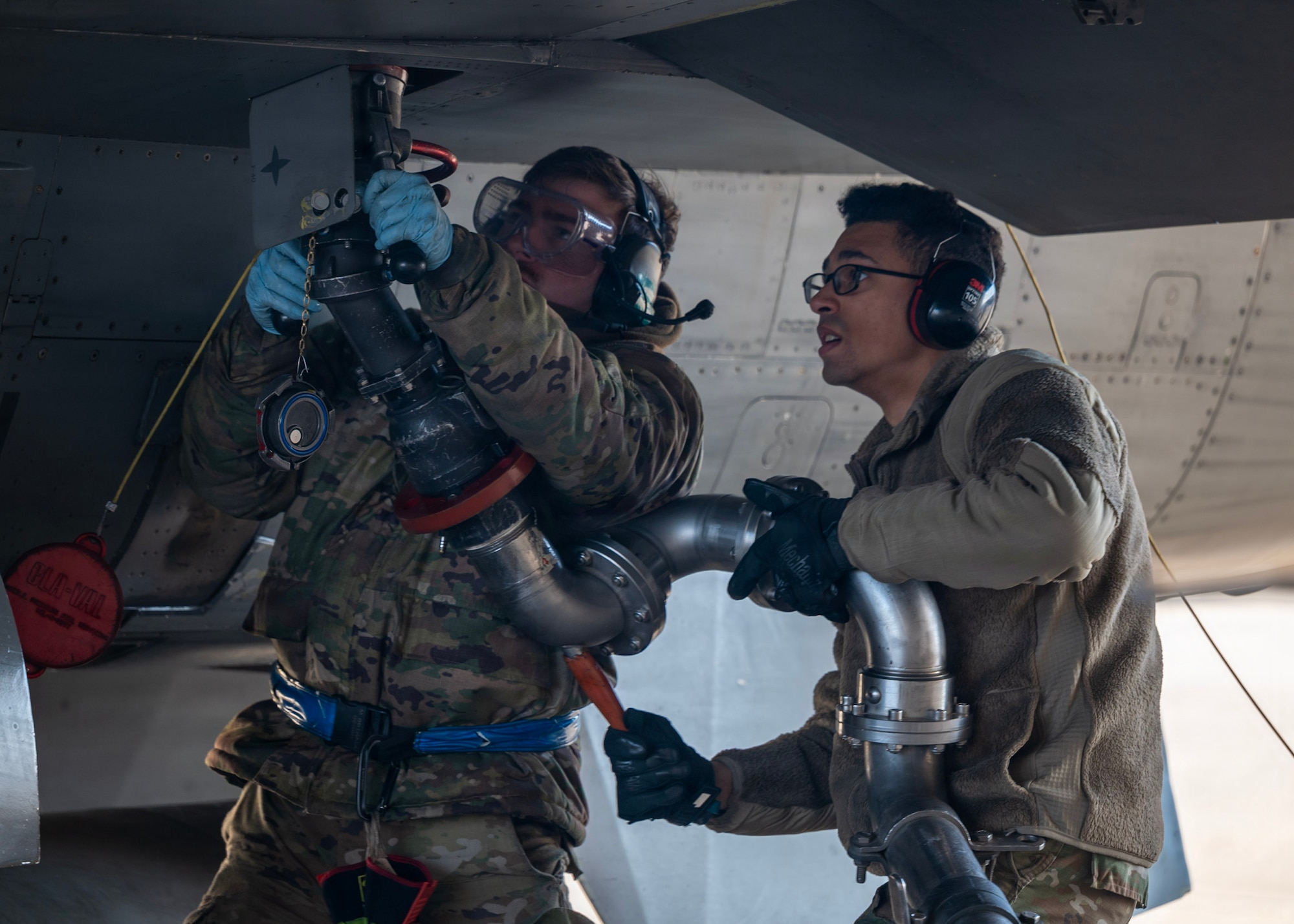 U.S. Air Force Senior Airman Michael Brignac, left, 35th Fighter Generation Squadron electrical and environmental specialist, and Airman 1st Class Benjamin Patterson, right, 51st Logistics Readiness Squadron petroleum, oils, and lubricants distribution operator, attach a pantograph to an F-16 Fighting Falcon during a hot-pit refueling operation at Osan Air Base, Republic of Korea, Jan. 27, 2026. Fixed fuel hydrant systems and pantographs, Airmen refuel aircraft directly from base fuel storage, reducing delays and sustaining combat airpower. (U.S. Air Force photo by Staff Sgt. Sarah Williams)
