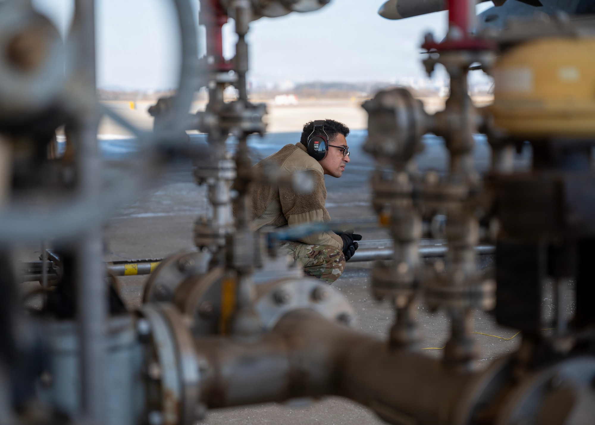 U.S. Air Force Airman 1st Class Benjamin Patterson, 51st Logistics Readiness Squadron petroleum, oils, and lubricants distribution operator, monitors a refueling during a hot-pit refueling operation at Osan Air Base, Republic of Korea, Jan. 27, 2026. 51st LRS increased the number of Airmen qualified to conduct hot-pit refueling from two to over two dozen, ensuring rapid response at a moment’s notice. (U.S. Air Force photo by Staff Sgt. Sarah Williams)