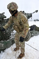 U.S. Paratroopers assigned to 4th Battalion, 319th Field Artillery Regiment, 173rd Airborne Brigade, prepare, load and fire an M777 Howitzer during Dynamic Front 26 at the Grafenwoehr Training Area, Grafenwoehr, Germany, Jan. 27, 2026. Dynamic Front is the practical application of the Eastern Flank Deterrence Line (EFDL) and enhances the U.S. and NATO's ability to coordinate lethal and non-lethal effects in a distributed battlefield. (U.S. Army photo by Pfc. Tomas J. Arce)