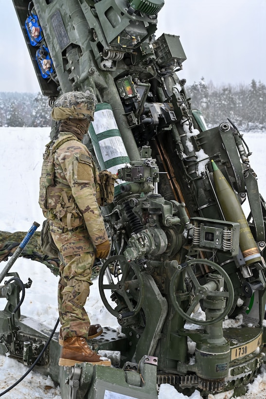 U.S. Paratroopers assigned to 4th Battalion, 319th Field Artillery Regiment, 173rd Airborne Brigade, prepare, load and fire an M777 Howitzer during Dynamic Front 26 at the Grafenwoehr Training Area, Grafenwoehr, Germany, Jan. 27, 2026. Dynamic Front is the practical application of the Eastern Flank Deterrence Line (EFDL) and enhances the U.S. and NATO's ability to coordinate lethal and non-lethal effects in a distributed battlefield. (U.S. Army photo by Pfc. Tomas J. Arce)