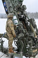 U.S. Paratroopers assigned to 4th Battalion, 319th Field Artillery Regiment, 173rd Airborne Brigade, prepare, load and fire an M777 Howitzer during Dynamic Front 26 at the Grafenwoehr Training Area, Grafenwoehr, Germany, Jan. 27, 2026. Dynamic Front is the practical application of the Eastern Flank Deterrence Line (EFDL) and enhances the U.S. and NATO's ability to coordinate lethal and non-lethal effects in a distributed battlefield. (U.S. Army photo by Pfc. Tomas J. Arce)