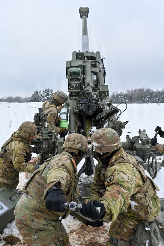 U.S. Paratroopers assigned to 4th Battalion, 319th Field Artillery Regiment, 173rd Airborne Brigade, prepare, load and fire an M777 Howitzer during Dynamic Front 26 at the Grafenwoehr Training Area, Grafenwoehr, Germany, Jan. 27, 2026. Dynamic Front is the practical application of the Eastern Flank Deterrence Line (EFDL) and enhances the U.S. and NATO's ability to coordinate lethal and non-lethal effects in a distributed battlefield. (U.S. Army photo by Pfc. Tomas J. Arce)