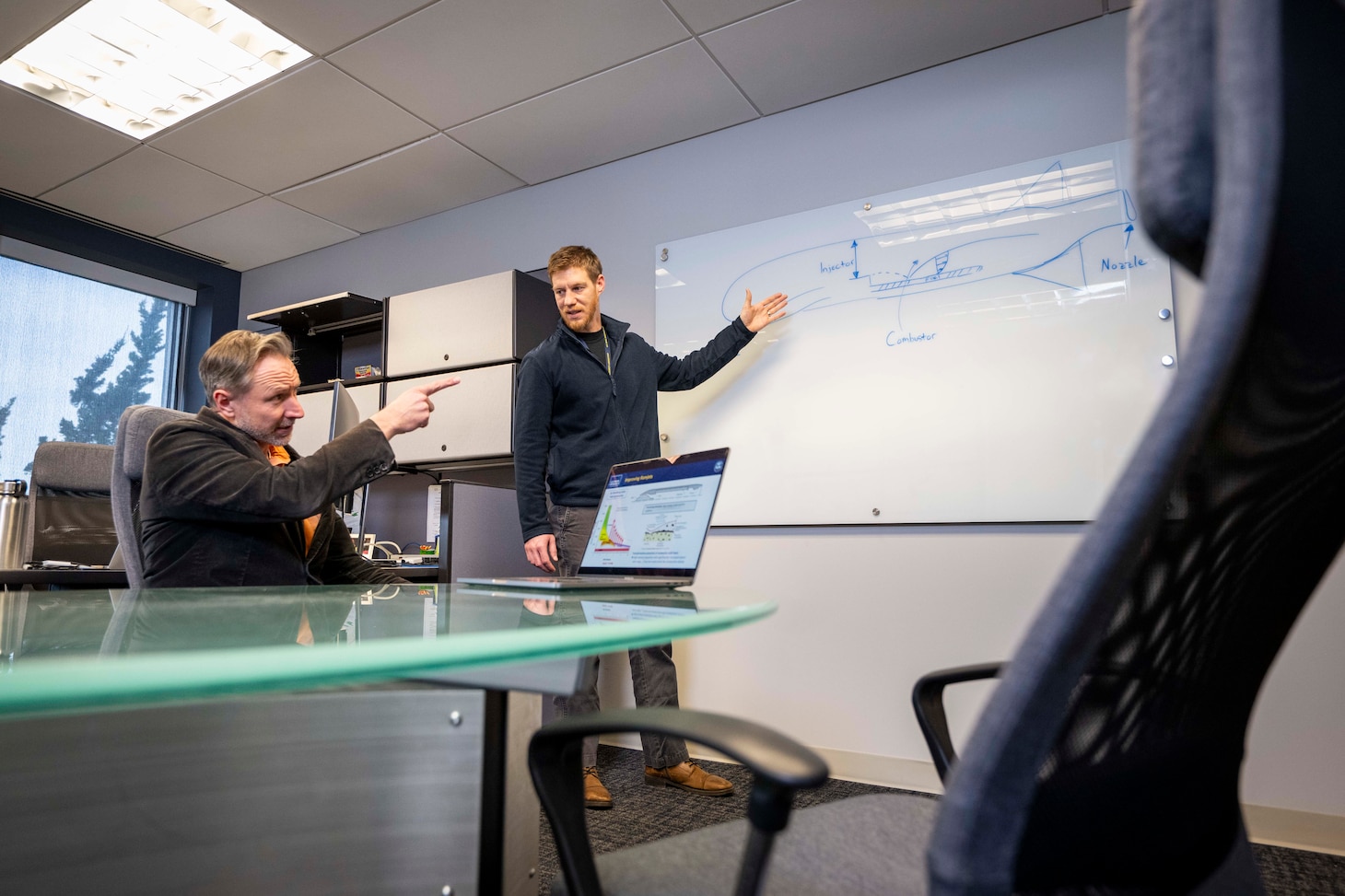 Brian Bojko (right), Ph.D., U.S. Naval Research Laboratory (NRL) mechanical engineer, and David Kessler, Ph.D., NRL director of Laboratories for Computational Physics and Fluid Dynamics, discuss solid-fuel ramjet (SFRJ) advancements in Washington, D.C., Jan. 13, 2026. Scientists at NRL use optical diagnostics to visualize combustion data and develop technologies that increase the range of high-speed SFRJ systems. (U.S. Navy photo by Sarah Peterson)