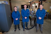 Clayton Geipel (left), Ph.D., U.S. Naval Research Laboratory (NRL) aerospace engineer; Nicholas Diskerud (center), Ph.D., NRC postdoctoral research associate and Brian Fisher, Ph.D., NRL mechanical engineer pose for a photo in the Combustion Lab in Chesapeake Beach, Maryland, Jan. 15, 2026. Scientists at NRL use an optically-accessible solid-fuel slab burner to perform combustion experiments in conditions relevant to solid-fuel ramjet flight. (U.S. Navy photo by Jonathan Sunderman)