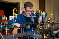 Clayton Geipel, Ph.D., U.S. Naval Research Laboratory (NRL) aerospace engineer, adjusts fittings on an optically-accessible solid-fuel slab burner at NRL’s Combustion Lab in Chesapeake Beach, Maryland, Jan. 15, 2026. Researchers and engineers at NRL use an optically-accessible solid-fuel slab burner to perform combustion experiments at conditions relevant to solid-fuel ramjet flight. (U.S. Navy photo by Jonathan Sunderman)