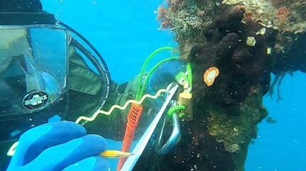 U.S. Navy Seabee divers, assigned to Underwater Construction Team One (UCT 1) Construction Dive Detachment Bravo (CDD/B), records data points to identify system changes during a dive in the Sea of Crete  Dec. 18, 2025.