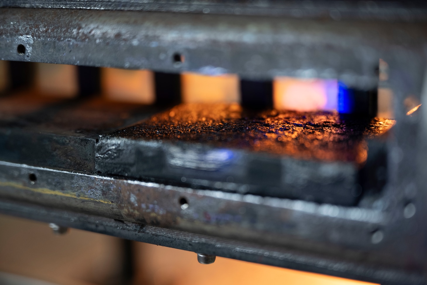 Featured is a carbon black composite fuel slab within an optically-accessible solid-fuel slab burner combustion chamber at the U.S. Naval Research Laboratory’s (NRL) Combustion Lab in Chesapeake Beach, Maryland, Jan. 15, 2026. Researchers and engineers at NRL use an optically-accessible solid-fuel slab burner to perform combustion experiments at conditions relevant to solid-fuel ramjet flight. (U.S. Navy photo by Jonathan Sunderman)