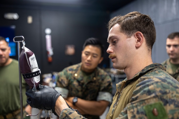U.S. Navy Lt. Antonia De Jesus, a nurse with 2nd Medical Battalion, 2nd Marine Logistics Group, practices drawing blood during a Tier IV Tactical Casualty Combat Care course at Marine Corps Base Camp Lejeune, North Carolina, Sept. 29, 2025. 2nd MLG became the first-ever Marine Corps command to host a Tier IV TCCC course and is now hosting its second iteration. The course trains select military service members to become proficient combat paramedics capable of providing advanced casualty care at the point of injury on the battlefield and in austere environments. (U.S. Marine Corps photo by Lance Cpl. Isabella Ramos)