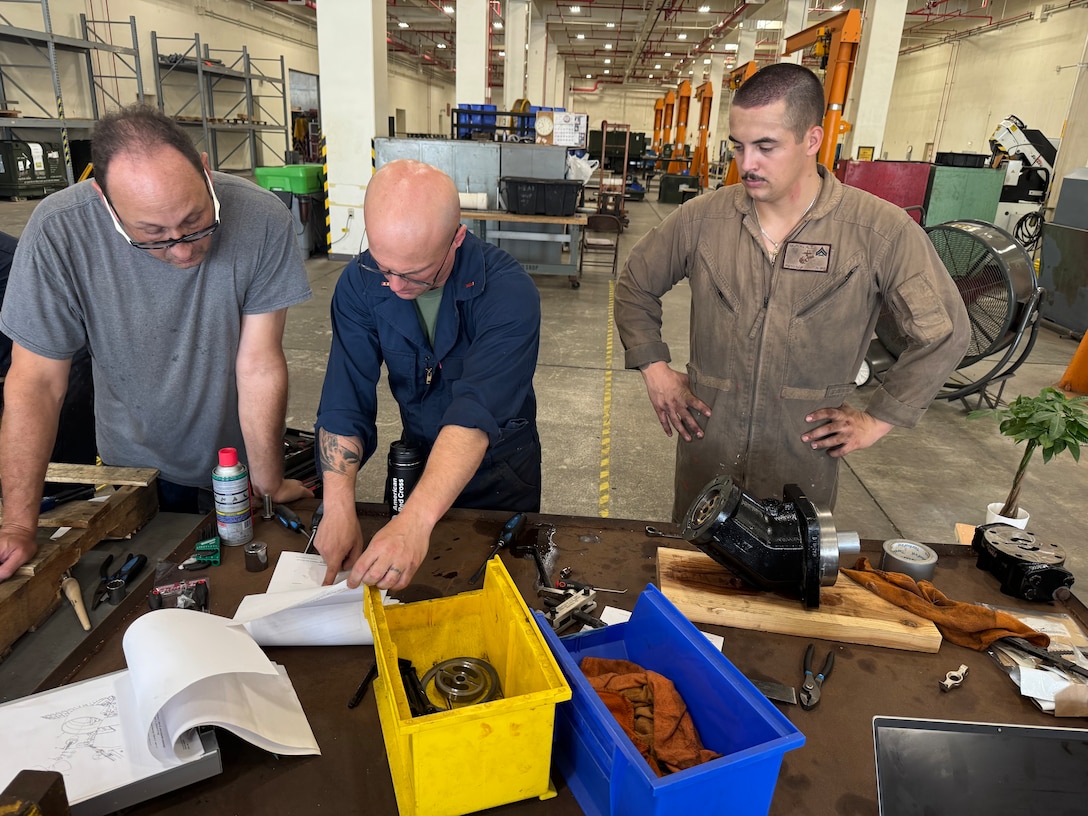 Marines with the General Support Maintenance Platoon, Intermediate Repair Company, 3d Maintenance Battalion, 3d Marine Logistics Group, review an Amphibious Combat Vehicle technical manual during component repair work at Camp Kinser, Okinawa, Japan, Nov. 13, 2025. Marines with the GSM Platoon, in concert with 3d Maint. Bn’s Manufacturing Platoon, has been building their ACV secondary repairable capabilities beyond the traditional scope of an intermediate-level repair facility, out-pacing Marine Corps Logistics Command to support the overall readiness of III Marine Expeditionary Force’s ACV units.