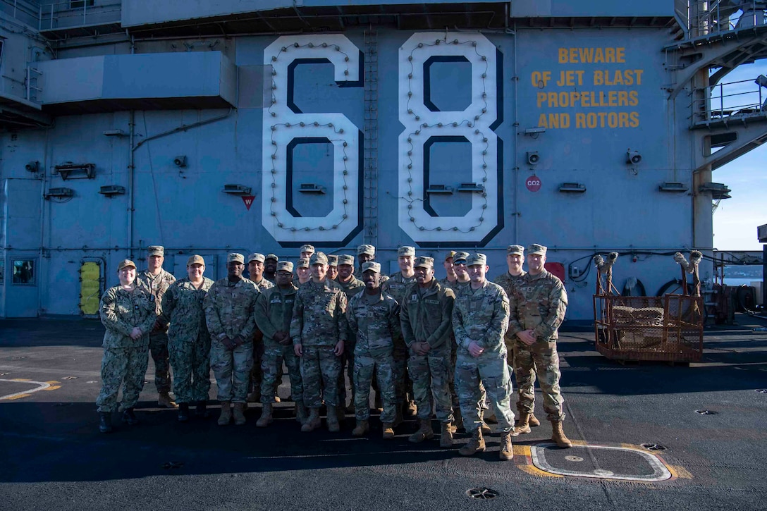U.S. Airmen and U.S. Soldiers conduct a promotion ceremony aboard the Nimitz-class aircraft carrier USS Nimitz (CVN 68) in Bremerton, Washington, Jan. 16, 2026. Nimitz is in port for a scheduled maintenance availability. (U.S. Navy photo by Mass Communication Specialist 2nd Class Timothy J. Meyer)