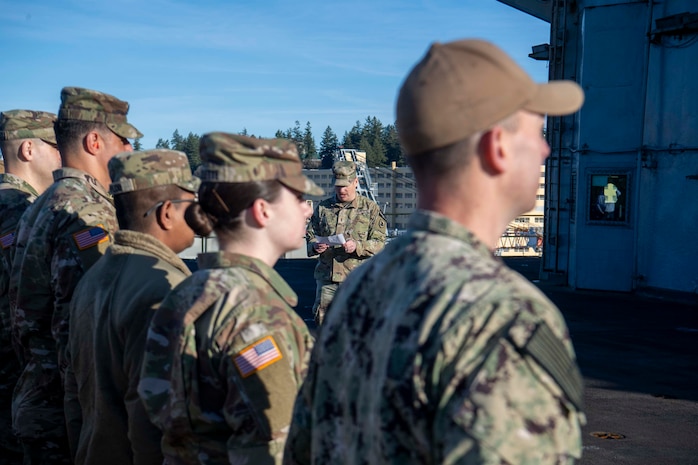 U.S. Airmen and U.S. Soldiers conduct a promotion ceremony aboard the Nimitz-class aircraft carrier USS Nimitz (CVN 68) in Bremerton, Washington, Jan. 16, 2026. Nimitz is in port for a scheduled maintenance availability. (U.S. Navy photo by Mass Communication Specialist 2nd Class Timothy J. Meyer)