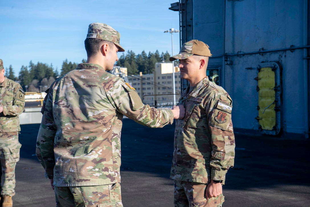 U.S. Airmen and U.S. Soldiers conduct a promotion ceremony aboard the Nimitz-class aircraft carrier USS Nimitz (CVN 68) in Bremerton, Washington, Jan. 16, 2026. Nimitz is in port for a scheduled maintenance availability. (U.S. Navy photo by Mass Communication Specialist 2nd Class Timothy J. Meyer)