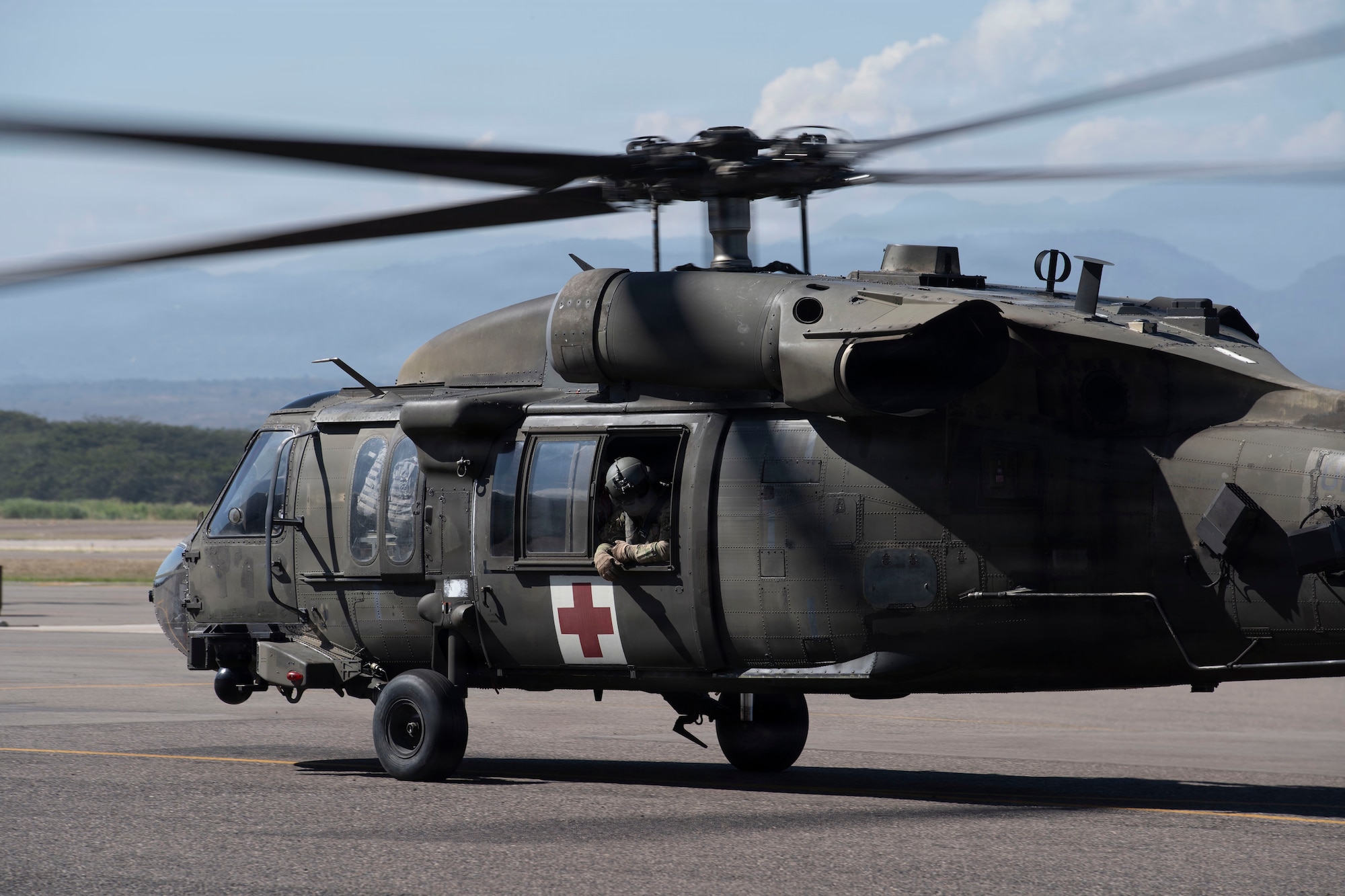 A military helicopter taxis out to the runway