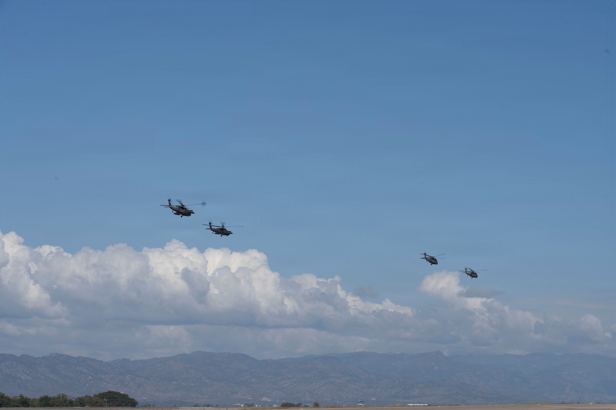 military helicopters fly in the sky