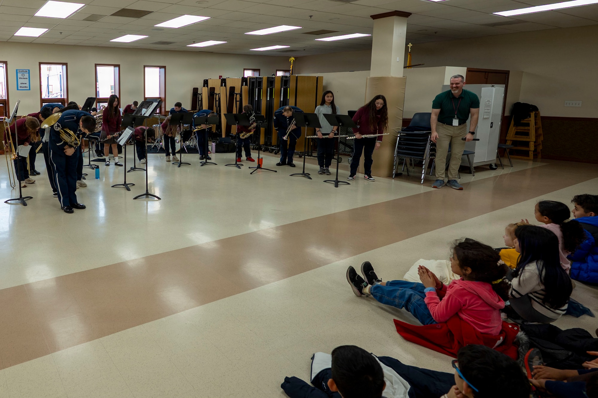 Students at St. Veronica’s Catholic School bow after performing alongside The Air Force Band’s District Brass in Chantilly, Va., Jan. 13, 2026. The group performed tunes from a variety of styles, including 1970s jazz, Latin dance, and Disney movie music to inspire and connect with the students. (U.S. Air Force photo by Staff Sgt. Jordan Powell)