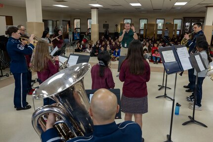 Students at St. Veronica’s Catholic School perform alongside The Air Force Band’s District Brass in Chantilly, Va., Jan. 13, 2026. The District Brass group was formed eight years ago to extend the outreach mission of the Ceremonial Brass to the local community. (U.S. Air Force photo by Staff Sgt. Jordan Powell)