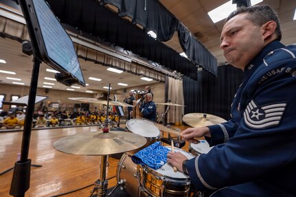 U.S. Air Force Tech. Sgt. Luis Rivera, percussionist with The U.S. Air Force Band’s Ceremonial Brass, performs with the District Brass at Gwynn Park Middle School, Brandywine, Md., Jan. 15, 2026. The group performed tunes from a variety of styles including 1970s jazz, Latin dance, and Disney movie music to inspire and connect with the students. (U.S. Air Force photo by Staff Sgt. Jordan Powell)