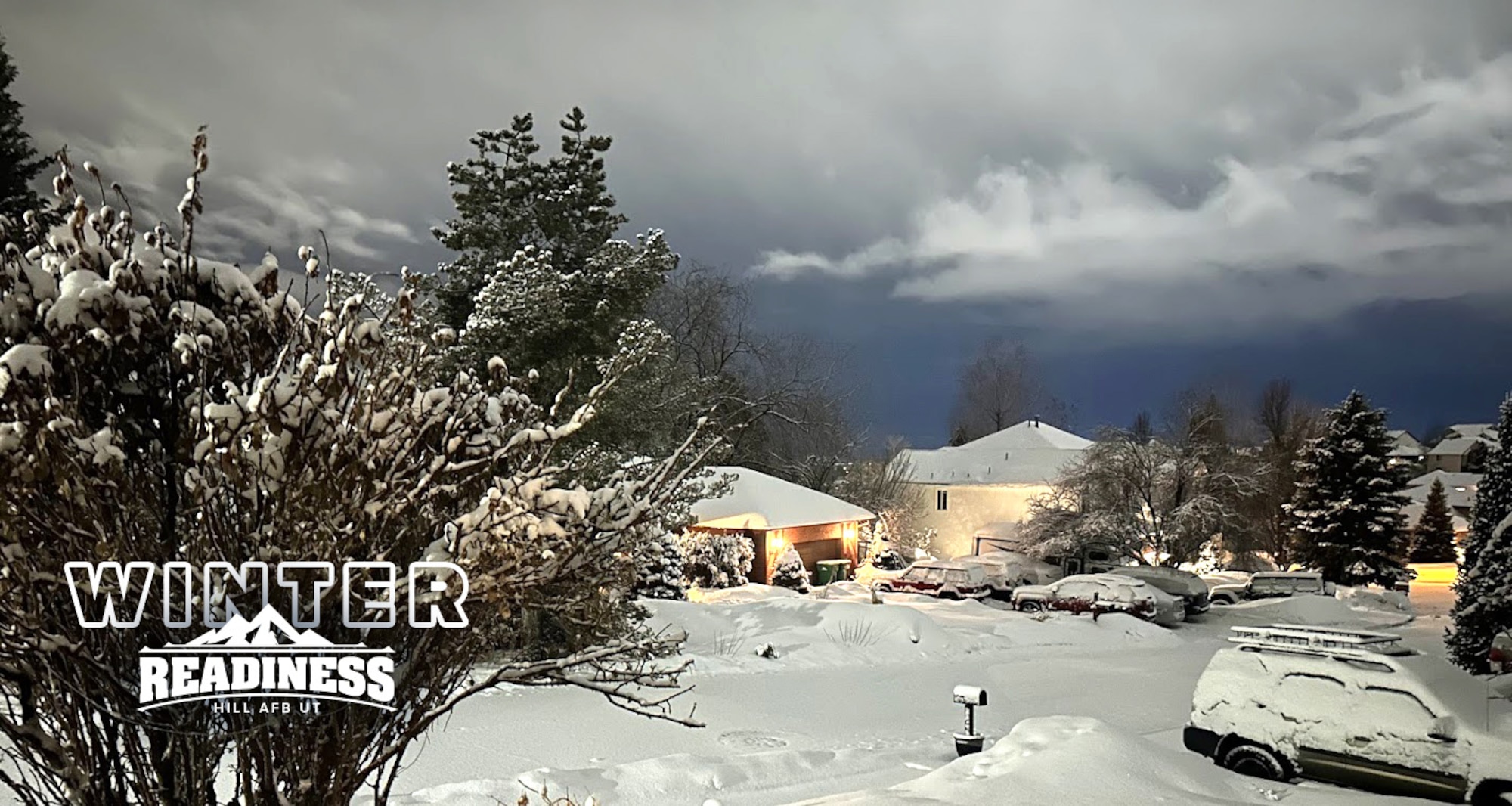 Snow blankets a neighborhood. A stylized mountain graphic in the bottom left-hand corner of the photo reads "winter readiness."