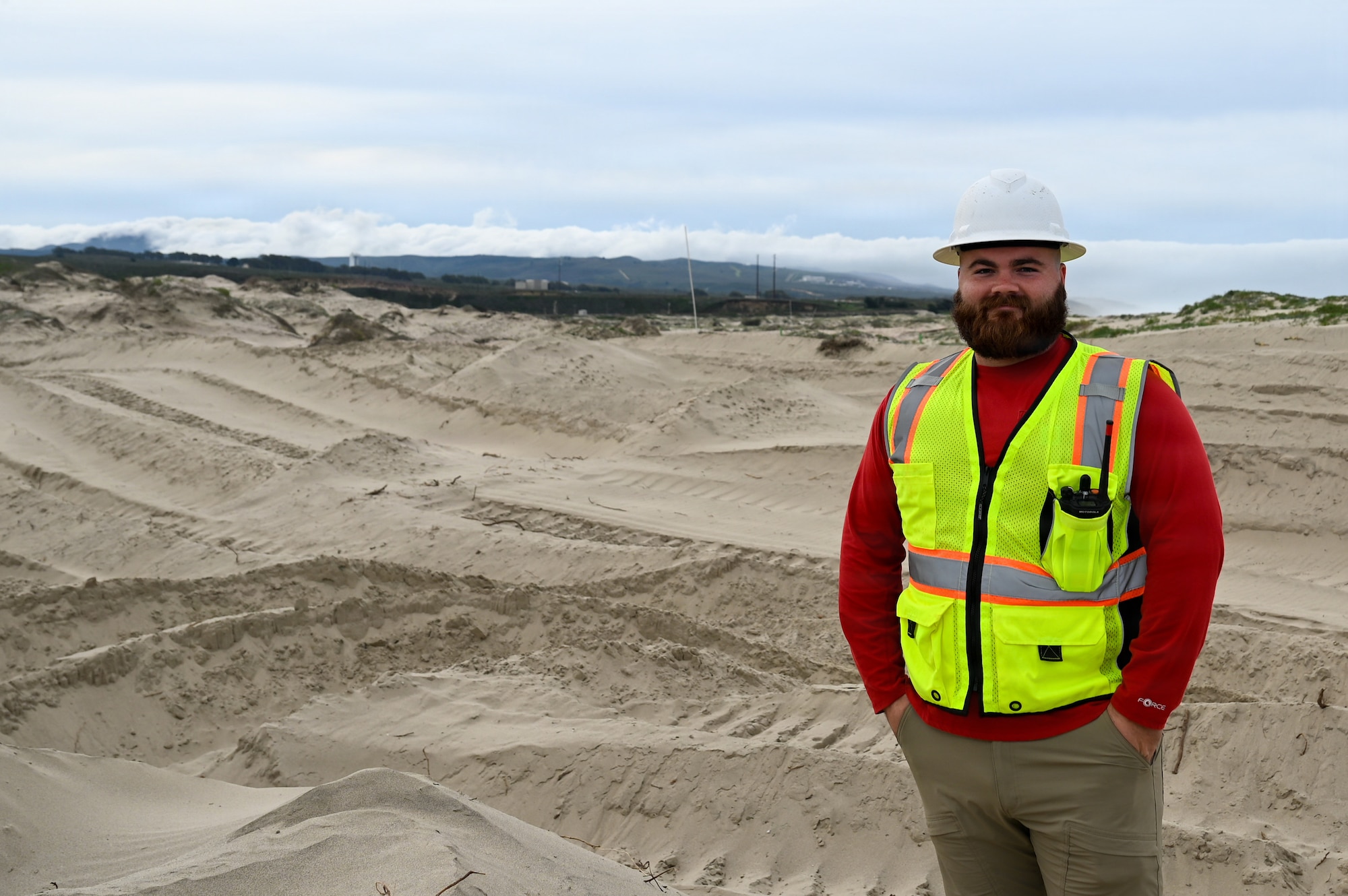 Jackson Taylor, 30th Civil Engineer Squadron biological scientist, stands on a dune habitat at Wall Beach at Vandenberg Space Force Base.