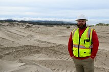 Jackson Taylor, 30th Civil Engineer Squadron biological scientist, stands on a dune habitat at Wall Beach at Vandenberg Space Force Base.