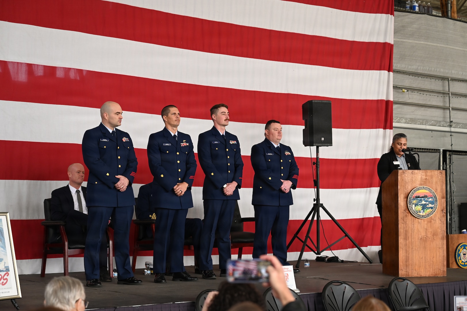 The San Diego Coastie of the Year nominees stand on stage, waiting for the announcement of the winner, Jan. 28, 2025. The annual award recognizes exemplary Coast Guard members from San Diego’s five local units. (U.S. Coast Guard photo by Petty Officer 3rd Class Trinity Whalen)
