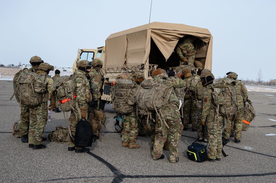 A group of defenders loading a cargo van.