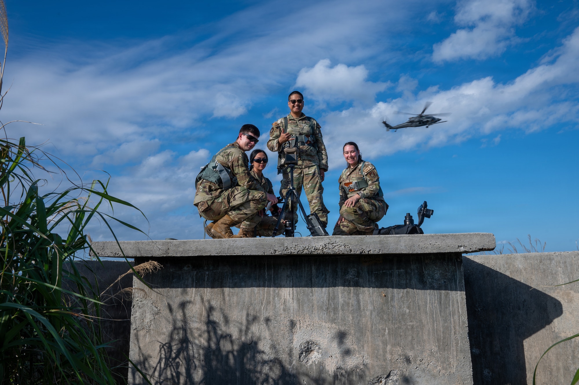 Servicemembers stand on a platform.