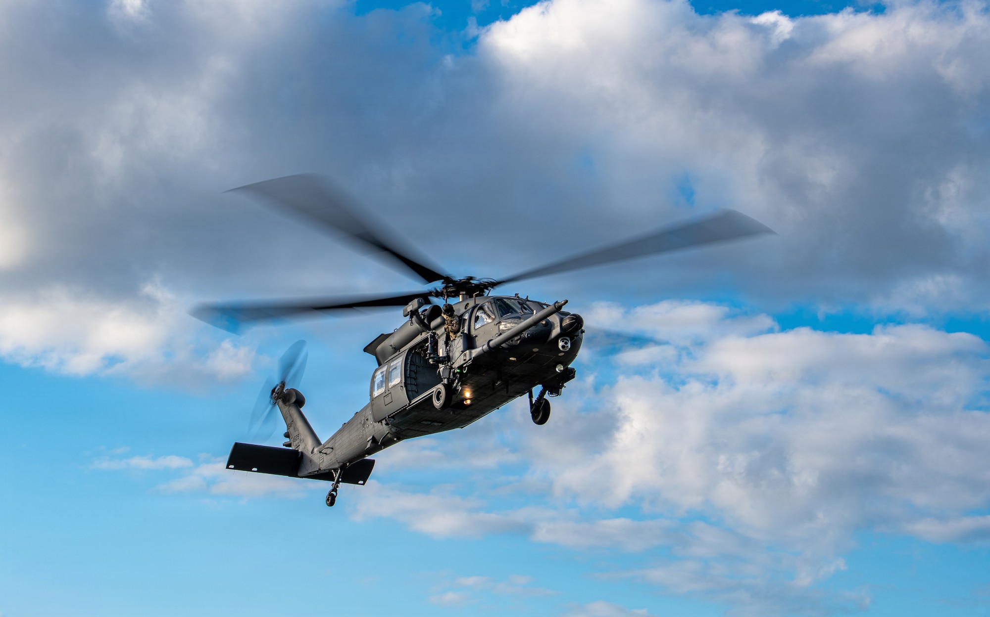 A U.S. Air Force HH-60W Jolly Green II helicopter prepares for ladning.