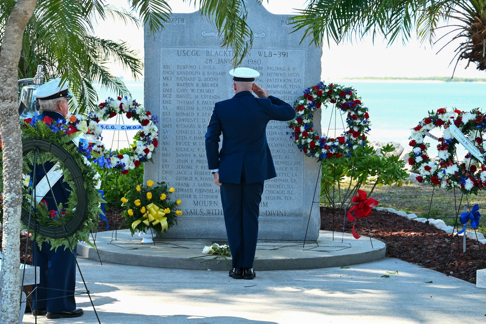 A Coast Guard Chief Petty Officer salutes at the memorial of the USCGC Blackthorn in St. Petersburg, Florida on Jan. 28, 2026.  Out of about 50 crew members, 23 members of the USCGC Blackthorn passed away in the disaster. (U.S. Coast Guard photo by Petty Officer 1st Class Riley Perkofski)