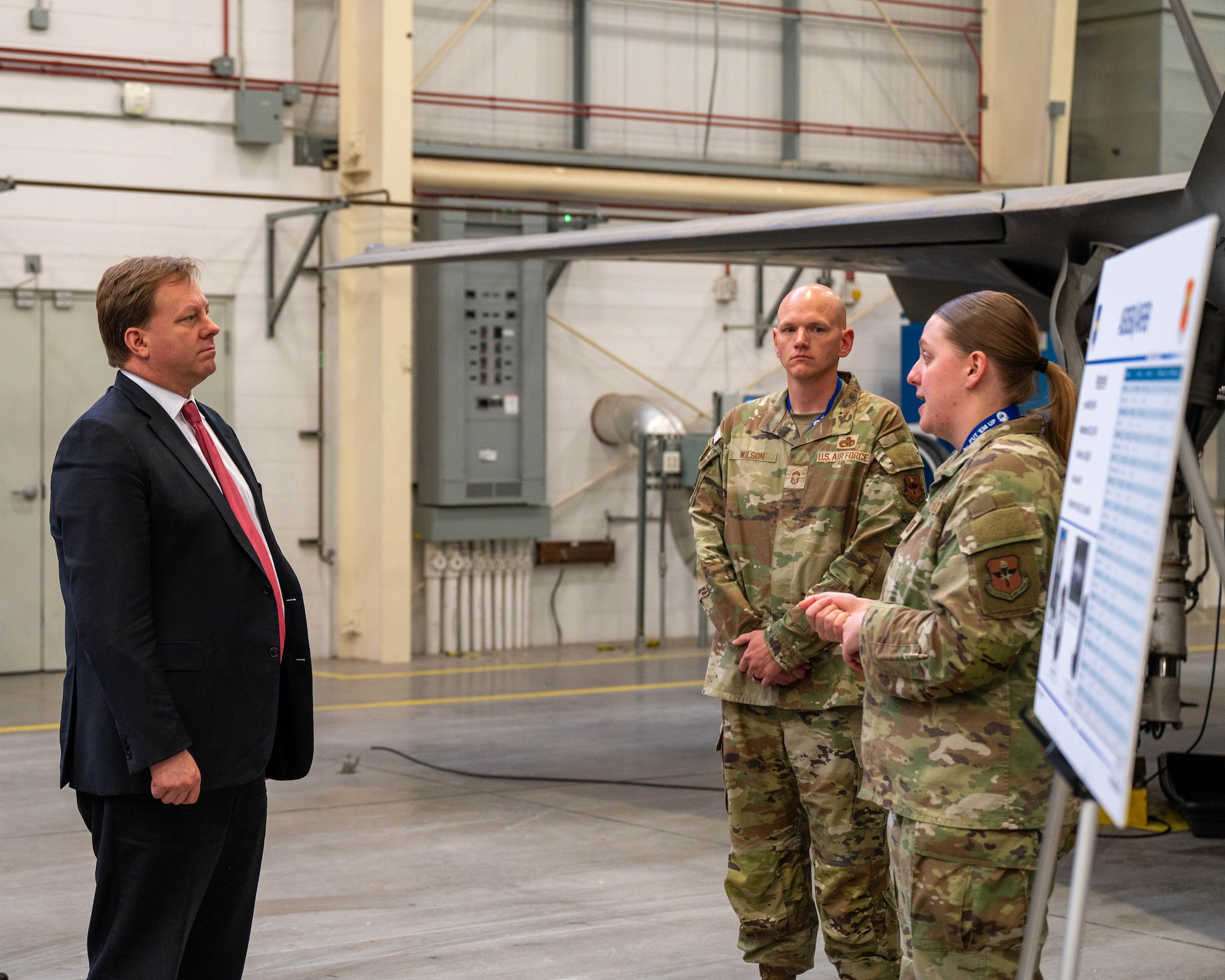 The Honorable Michael Duffey (left), Under Secretary of War for acquisition and sustainment, discusses aircraft maintenance operations with U.S. Air Force Capt. Alexis Andros (right), 62nd Aircraft Maintenance Unit officer in charge, and U.S. Air Force Chief Master Sgt. Robert Wilson (middle), 62nd AMU senior enlisted leader, Jan. 21, 2026, at Luke Air Force Base, Arizona.
