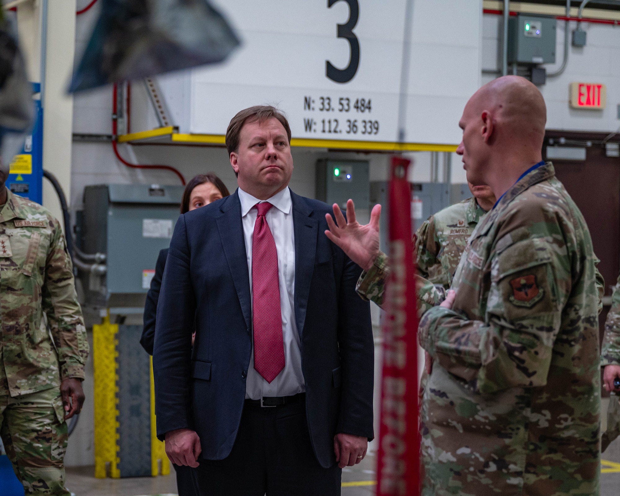 The Honorable Michael Duffey (center), Under Secretary of War for acquisition and sustainment, discusses aircraft maintenance operations with U.S. Air Force Chief Master Sgt. Robert Wilson (right), 62nd Aircraft Maintenance Unit senior enlisted leader, Jan. 21, 2026, at Luke Air Force Base, Arizona.