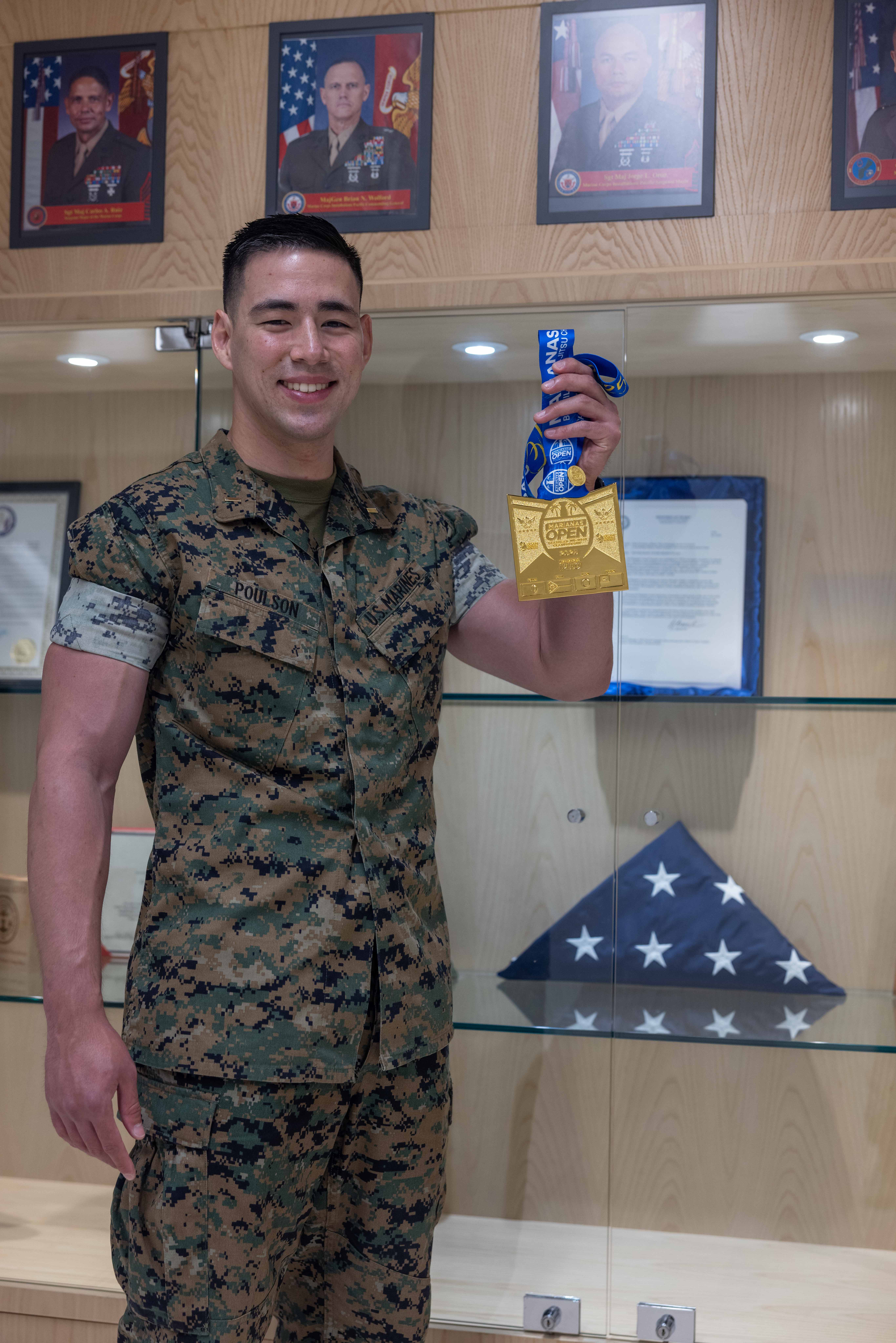 U.S. Marine Corps 2nd Lt. Joshua Poulson, adjutant, Headquarters Company, Marine Corps Base Camp Blaz, poses for a photo at MCB Camp Blaz, Guam, Oct. 28, 2025. Poulson displays the medal he earned from winning 1st place at the Guam Marianas Open International Brazilian Jiu jitsu Championship. (U.S. Marine Corps photo by Lance Cpl. Rey Moreno Marilao)