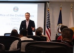 260123-N-CH185-1002 (Jan. 23, 2026) FALLS CHURCH, Va. Dr. Michael B. McGinnis, executive director of U.S. Navy Bureau of Medicine and Surgery, and director of the Navy Medicine Civilian Corps, speaks during a town hall at Defense Health Headquarters, Jan. 23. With a community of more than 2,000 civilian employees in over 119 different occupations across the globe, the Navy Medicine Civilian Corps play a critical and foundational role in helping the Department of the Navy meet its mission and support our warfighters. (U.S. Navy photo by Kaylon Chladek)