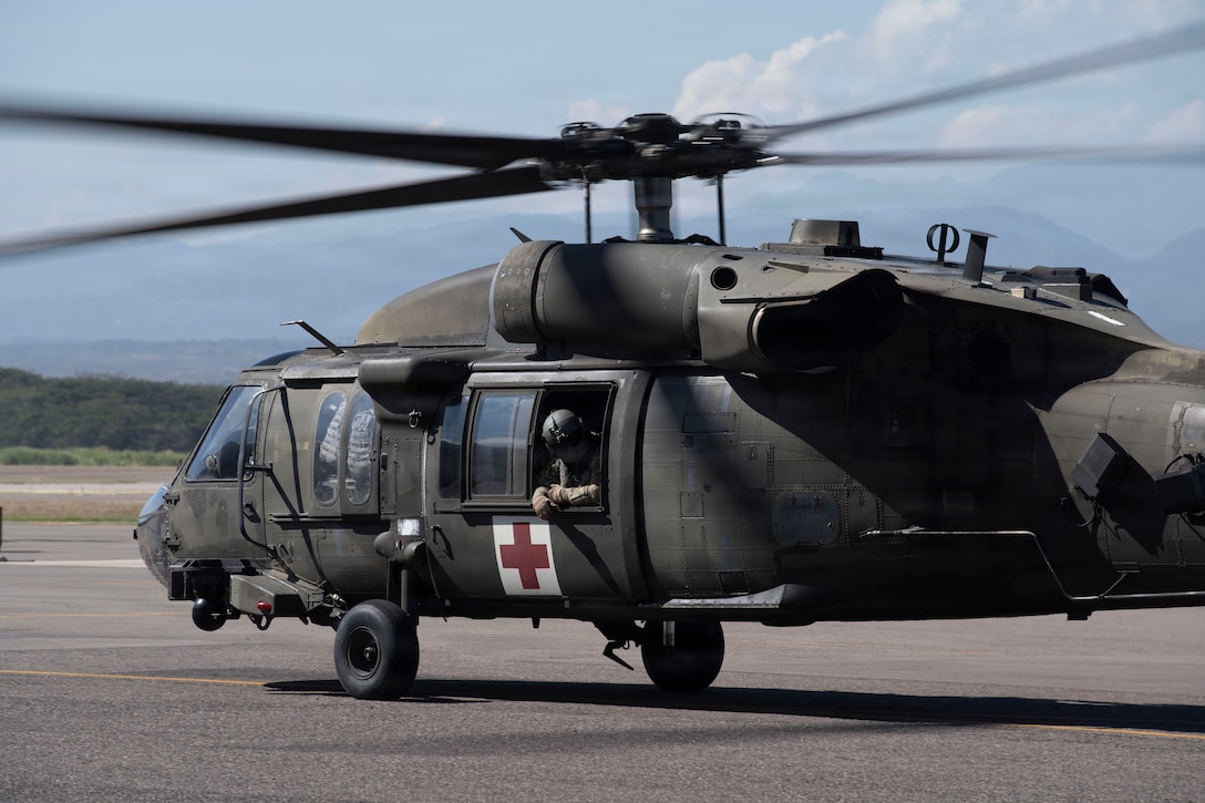 A military helicopter taxis out to the runway
