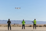 Members of the Experimental Test Force and private industry conduct a performance-based sUAS experiment during the inaugural "Game of Drones" event held at Edwards AFB, CA Dec. 8-12. The week-long effort brought together six industry partners and engineers from the Air Force Research Laboratory to conduct live experimentation of emerging small unmanned aerial systems (sUAS) and associated hardware. As the battlefield continues to diversify, the Department of War has called upon both service and industry to rapidly accelerate testing, acquisition, and production of unmanned systems for the warfighter, referred to as Drone Dominance. “Game of Drones” offers a speed-of-now playbook to meet this intent, going from idea to execution in less than four months. In "Game of Drones", industry partners from emerging to established can rapidly design, 3D-print, and test sUAS systems through agile experimentations across multiple domains such as C2 interoperability, counter-sUAS, rapid field printing, and autonomous swarming. The combination of collaboration and real-time feedback will help users from across the joint services identify key technologies and designs to expand the Department of War’s Blue List, a program that allows for rapid selection of approved unmanned aerial systems.  (Photo by Christian Raterman)
