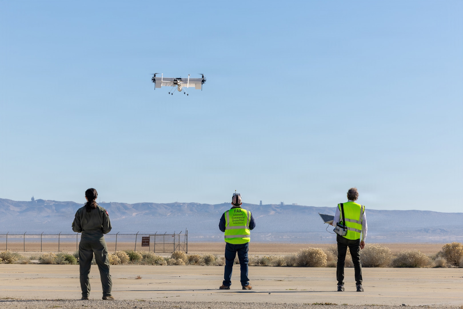 Members of the Experimental Test Force and private industry conduct a performance-based sUAS experiment during the inaugural "Game of Drones" event held at Edwards AFB, CA Dec. 8-12. The week-long effort brought together six industry partners and engineers from the Air Force Research Laboratory to conduct live experimentation of emerging small unmanned aerial systems (sUAS) and associated hardware. As the battlefield continues to diversify, the Department of War has called upon both service and industry to rapidly accelerate testing, acquisition, and production of unmanned systems for the warfighter, referred to as Drone Dominance. “Game of Drones” offers a speed-of-now playbook to meet this intent, going from idea to execution in less than four months. In "Game of Drones", industry partners from emerging to established can rapidly design, 3D-print, and test sUAS systems through agile experimentations across multiple domains such as C2 interoperability, counter-sUAS, rapid field printing, and autonomous swarming. The combination of collaboration and real-time feedback will help users from across the joint services identify key technologies and designs to expand the Department of War’s Blue List, a program that allows for rapid selection of approved unmanned aerial systems.  (Photo by Christian Raterman)