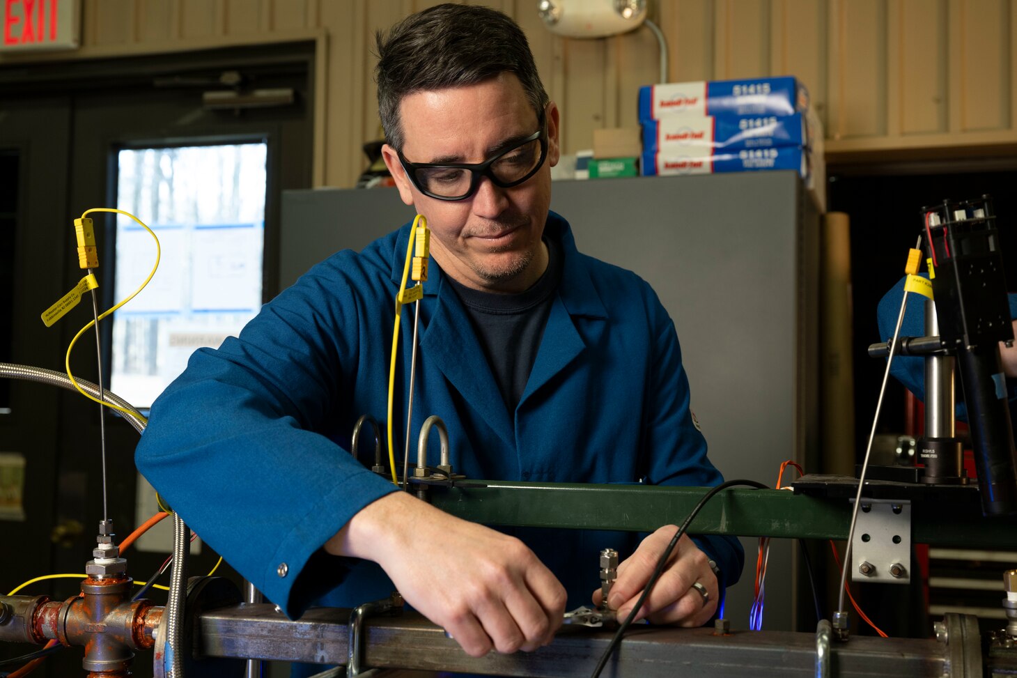 Brian Fisher, Ph.D., U.S. Naval Research Laboratory mechanical engineer, adjusts fittings on an optically-accessible solid-fuel slab burner at NRL’s Combustion Lab in Chesapeake Beach, Maryland, Jan. 15, 2026. Researchers and engineers at NRL use an optically-accessible solid-fuel slab burner to perform combustion experiments at conditions relevant to solid-fuel ramjet flight. (U.S. Navy photo by Jonathan Sunderman)