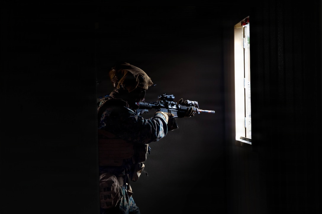 A U.S. Marine with 3rd Battalion, 2nd Marine Regiment, 24th Marine Expeditionary Unit, scans for enemy personnel during a force-on-force training exercise at Marine Corps Base Camp Lejeune, North Carolina, Jan. 6, 2026. The 24th MEU is a Marine Air Ground Task Force ready to answer our Nation's call in any clime and place. (U.S. Marine Corps photo by Cpl. Daniel Childs)