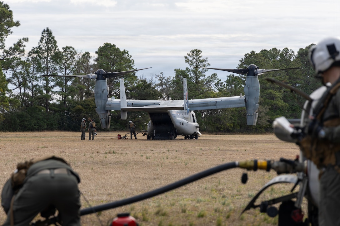 U.S. Marines with Marine Medium Tiltrotor Squadron (VMM) 365 (Reinforced), 24th Marine Expeditionary Unit, refuel a MV-22B Osprey during an aviation delivered ground refueling exercise at Marine Corps Base Camp Lejeune, North Carolina, Jan. 23, 2026. This training enhances the readiness of the 24th MEU by providing its Marines the capability to refuel aircraft at forward locations, extending their operational range and time on station. (U.S. Marine Corps photo by Lance Cpl. Allison White)